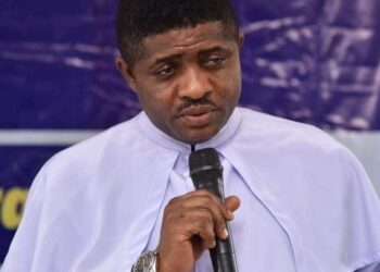 Catholic Priest shades tears as widows give donation for church building